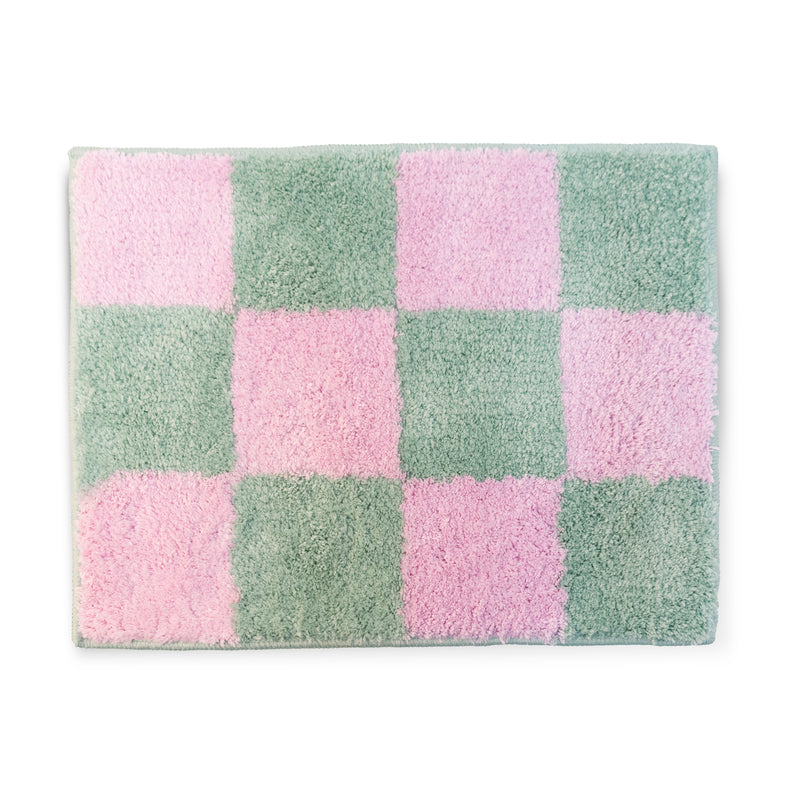 Alfombrilla de baño con estampado de cuadros rosas y verdes.