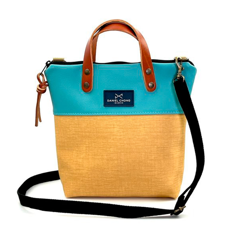 Bandolera mini impermeable con asas Daniel Chong - Asas marrón cuerpo azul y amarillo