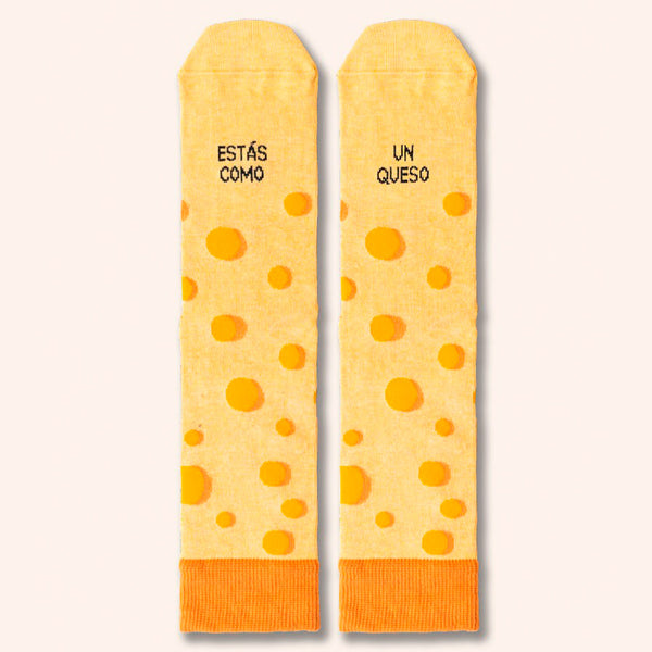 Calcetines amarillos que imitan un queso gruyere con la frase "estas como un queso".