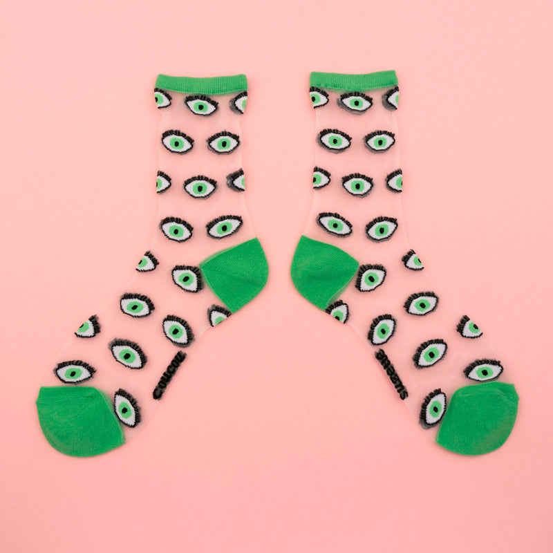 Calcetines de malla transparentes con dibujos de ojos verdes. Calcetines con estampado de ojos  con el remate, el talón y la punta en verde.