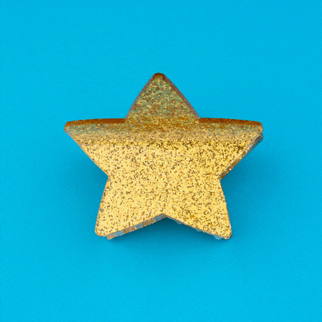 Pinza para el pelo en forma de estrella dorada. Pinza para el pelo estrella con acabado de purpurina dorada. Pinza para el pelo de acetato de celulosa reciclado ecológico.