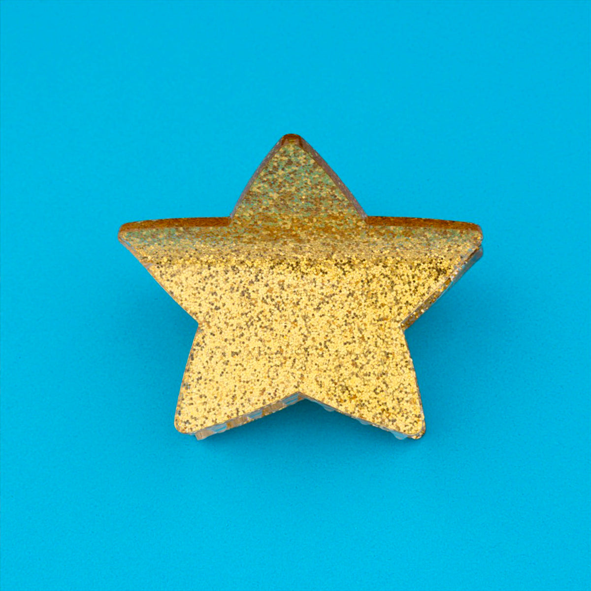 Pinza para el pelo en forma de estrella dorada. Pinza para el pelo estrella con acabado de purpurina dorada. Pinza para el pelo de acetato de celulosa reciclado ecológico.