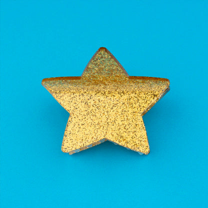 Pinza para el pelo en forma de estrella dorada. Pinza para el pelo estrella con acabado de purpurina dorada. Pinza para el pelo de acetato de celulosa reciclado ecológico.