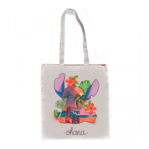Tote bag inspirada en la película de Disney Lilo y Stitch.  Bolsa de algodón con ilustración de silueta del personaje Stitch con una escena de paisaje de playa y hojas tropicales alrededor.