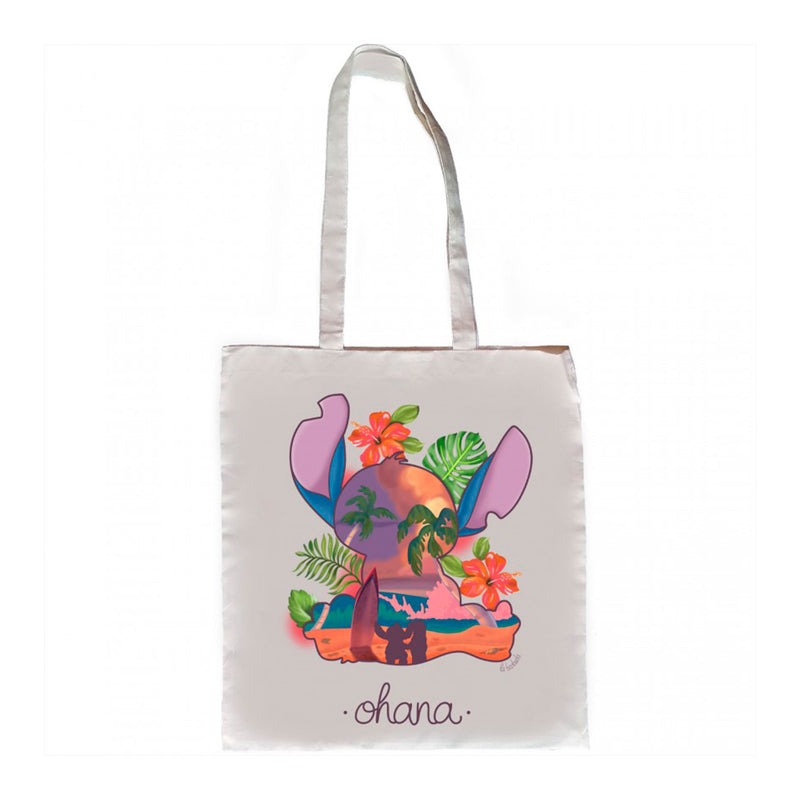 Tote bag inspirada en la película de Disney Lilo y Stitch.  Bolsa de algodón con ilustración de silueta del personaje Stitch con una escena de paisaje de playa y hojas tropicales alrededor.